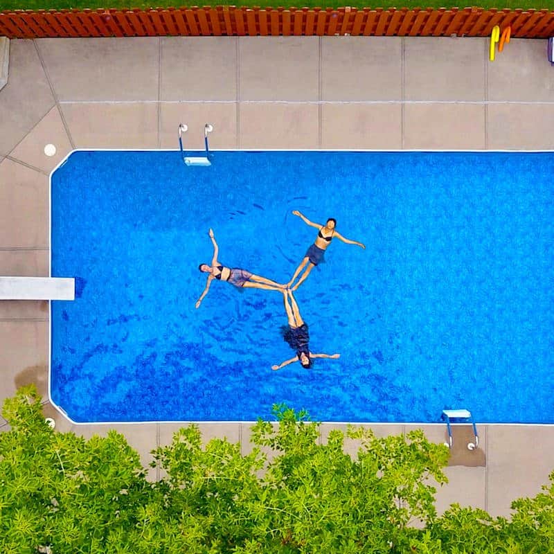 Three people in a pool Three people in a pool